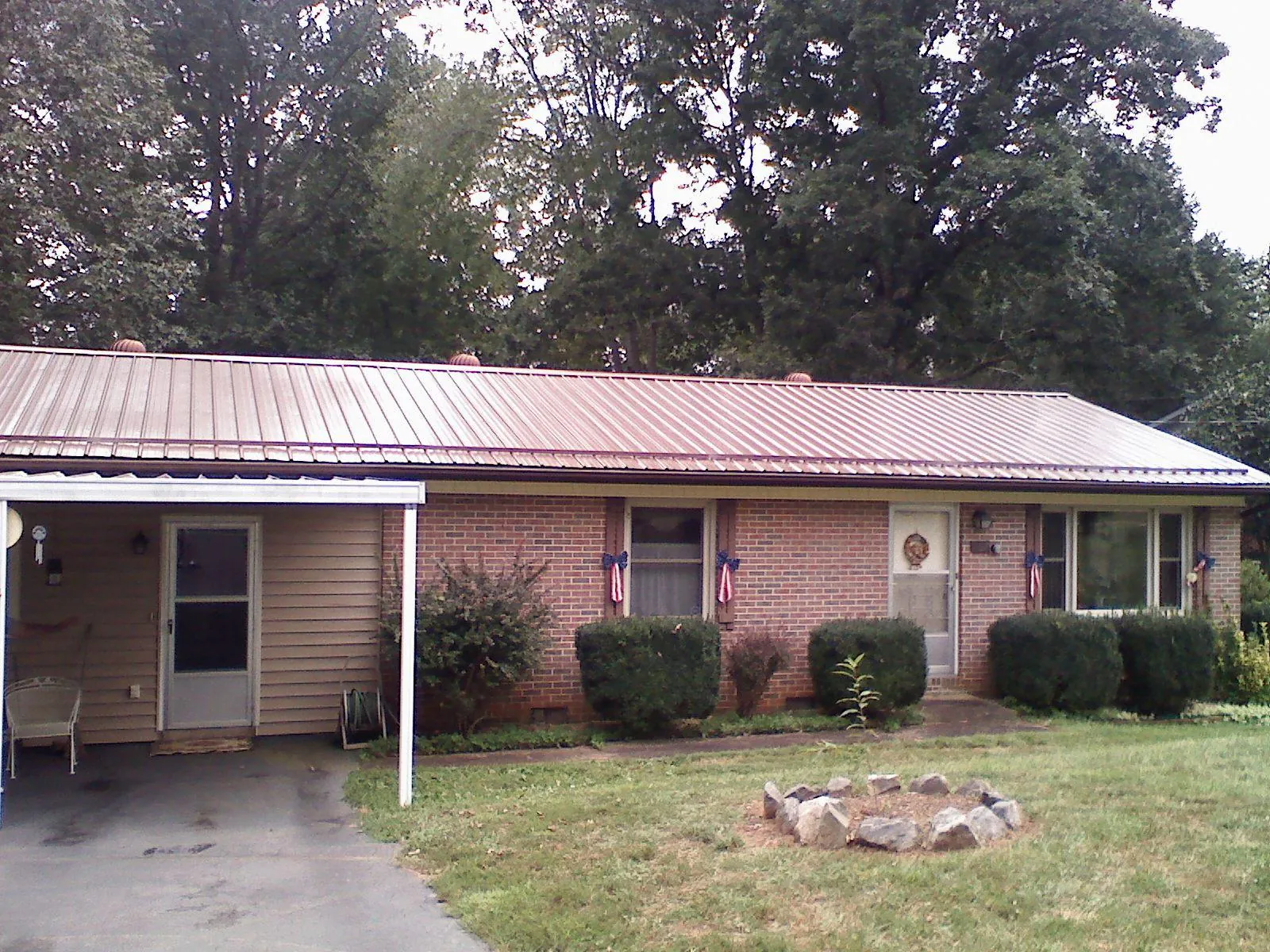 Bronze metal roof and carport on a brick ranch home — Roof Repair work by our crew in San Tan Valley